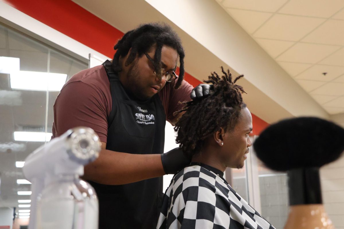 Mohammed Fahnbulleh, a sophomore majoring in civil engineering, gets a lineup by Franco Irvin during the Why Knot Us Barbershop Talk at the Preston Center on Sept. 13, 2023.