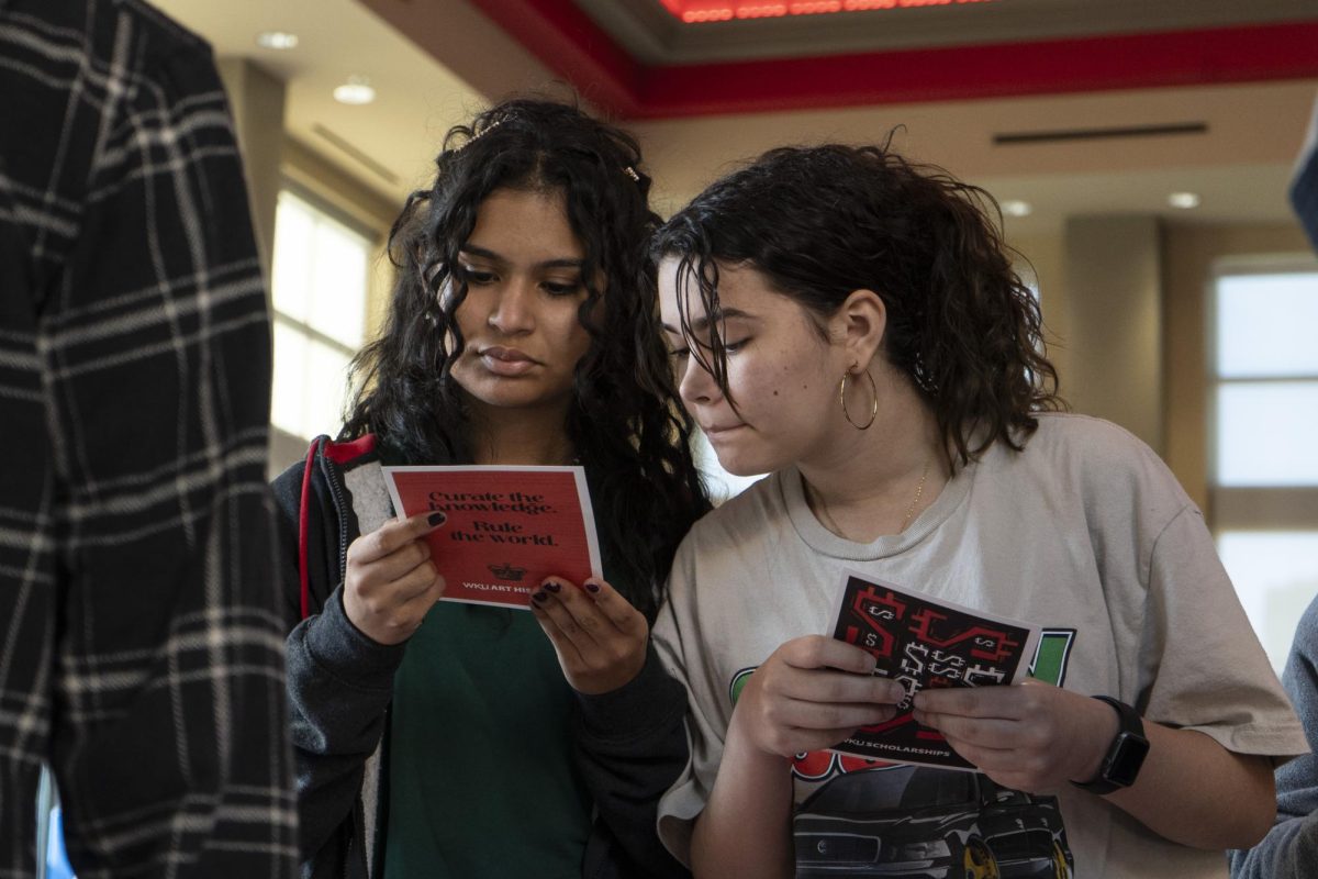 Two students read a brochure at Hispanic VIP Day hosted by WKU on Oct 18, 2023. 