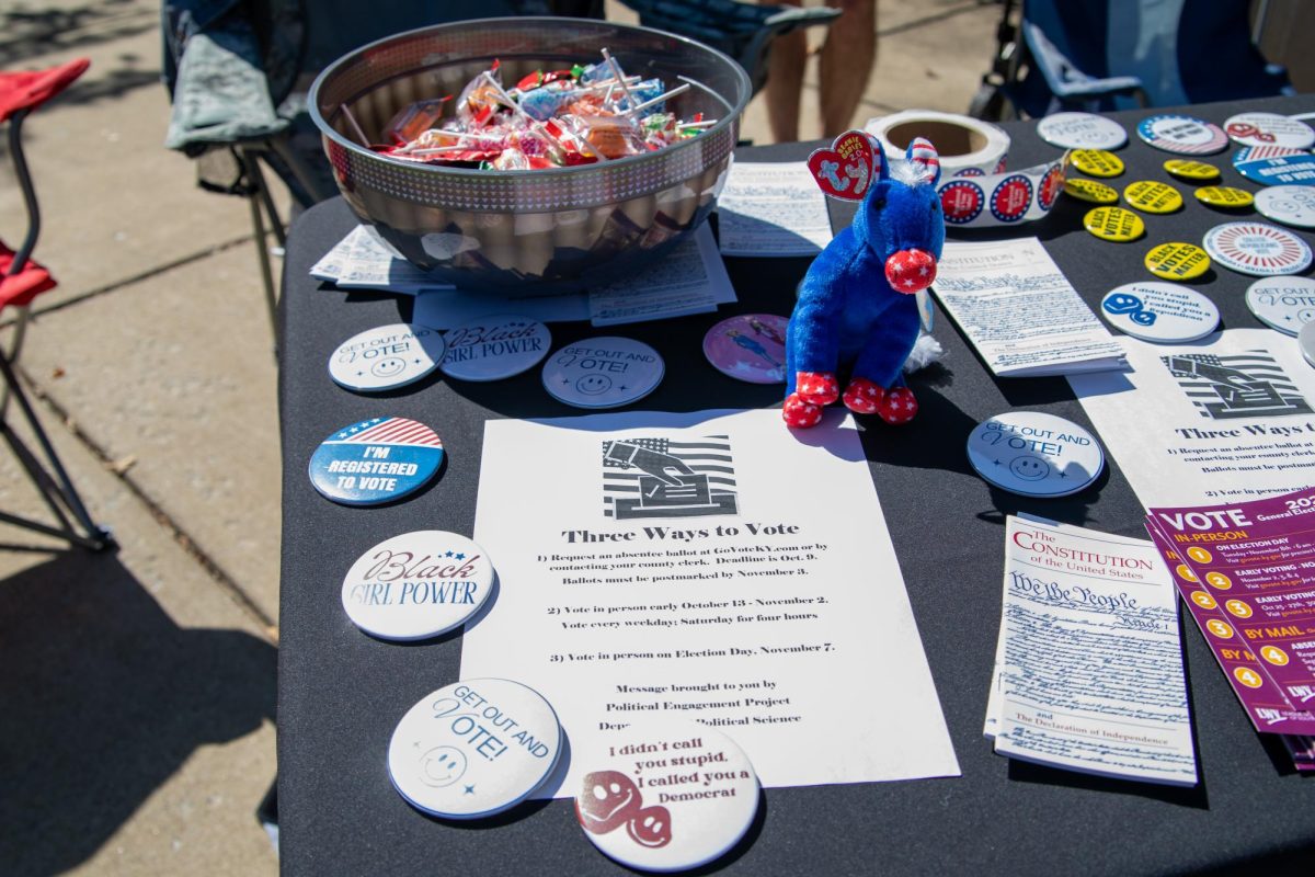 Buttons and informational pamphlets are seen at a Political Science Department table during Rock the Vote in front of Cherry Hall mid-September to encourage students to vote.