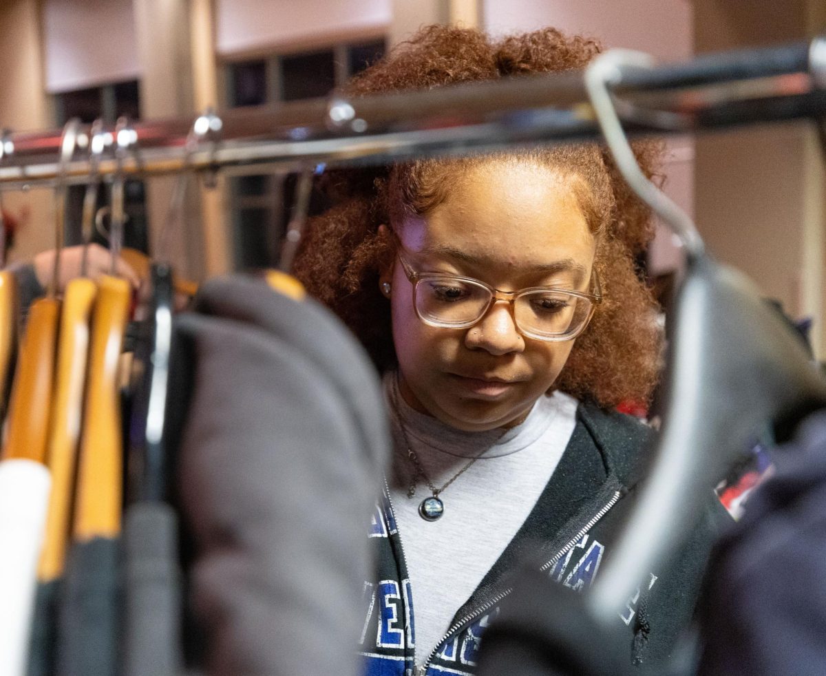 Freshman Unity Pickett looks through a clothing rack during the Throwback Thrift Fair at the Downing Student Union  on Thursday, Nov. 9, 2023.  