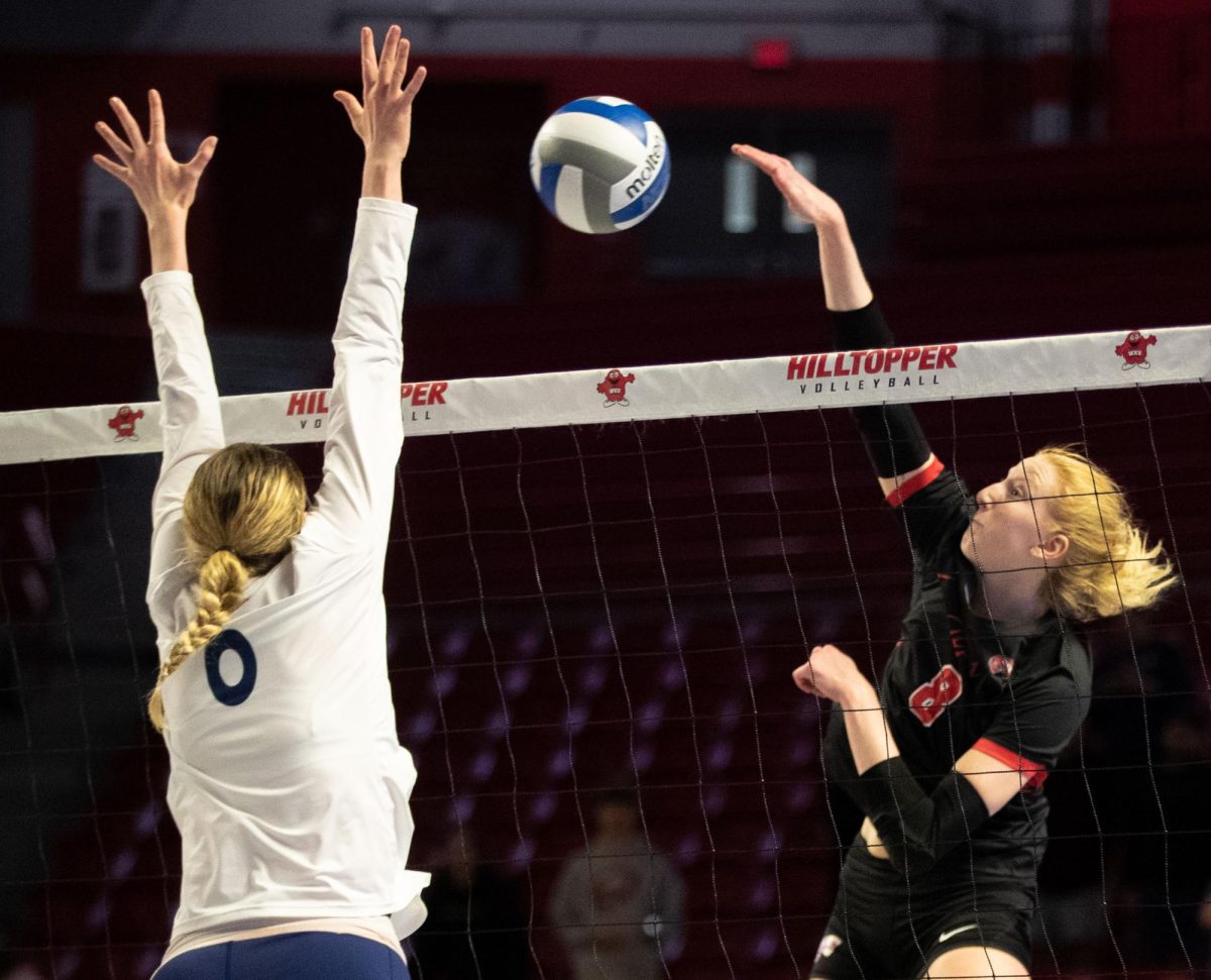 Outside hitter Kaylee Cox (8) spikes the ball over the net during a match against Florida International University at the E.A. Diddle Arena in Bowling Green on Saturday, Nov. 4, 2023. 