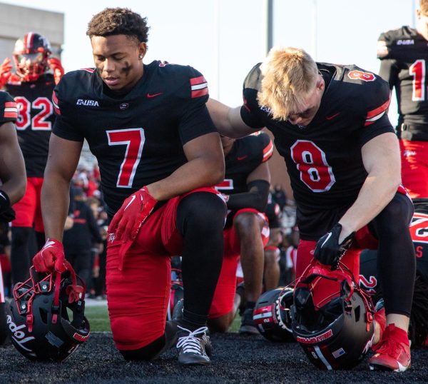 Running back L.T. Sanders (7), left, and Easton Messer (8) pray before their game against Sam Houston State University at L.T Smith Stadium in Bowling Green on Saturday, Nov. 18, 2023.