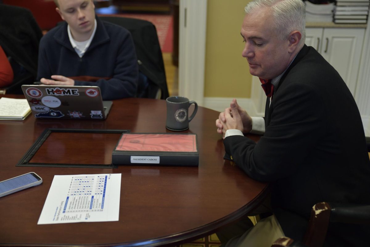 President Caboni looks at a chart with data about state performance funding showing that WKU only met two of 11 categories during meeting with the College Heights Herald editorial board on Wednesday, Jan. 10, 2024. 