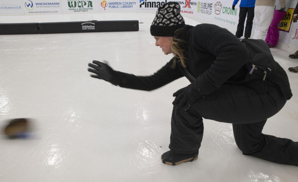 Karen Buchanon launches a skillet down the ice during their first game of the night at the Cast Iron Skillet Curling League on Wednesday, Jan. 17.