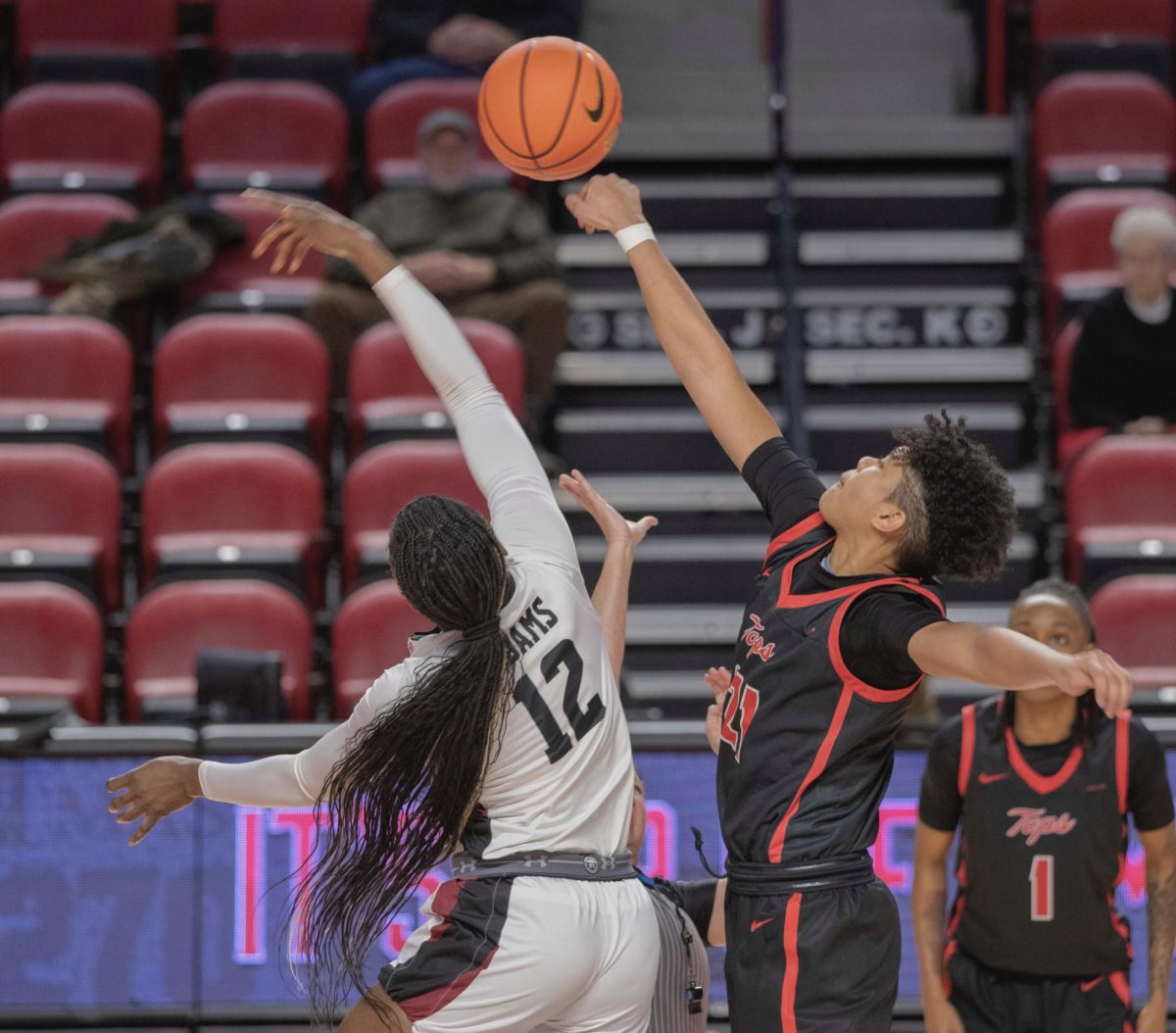 Forward Odeth Betancourt (21), right, jumps for the ball during the tipoff against New Mexico State Universitys Ene Adams (12) on Thursday, Jan. 18, 2024. 
