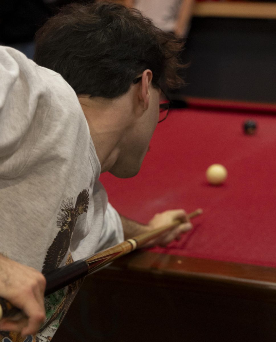 Colby Alexander, a junior journalism major, and Pool Club president, shoots the cue ball at the eight ball sending it into the corner pocket to win the match, during the WKU Pool Club’s first meeting of the spring 2024 semester, on Monday, Jan. 22, 2024, in the recreation area in Downing Student Union.
