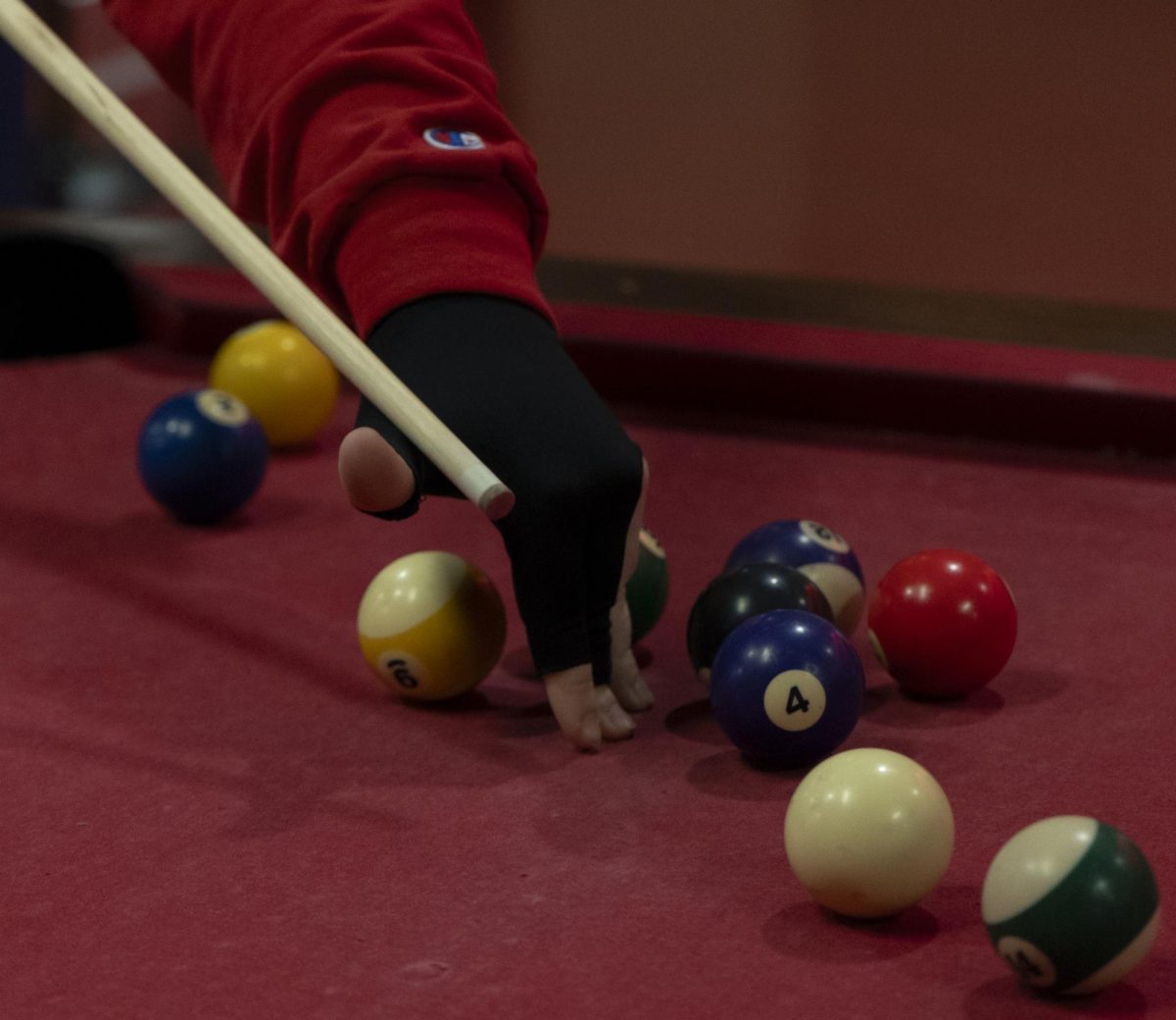 Andrew Ward, a sophomore accounting major, balances his cue above the nine ball for a better angle on the cue ball. “I wear a shooting glove to help prevent friction,” Ward explains during the WKU Pool Club’s first meeting of the spring 2024 semester, on Monday, Jan. 22, 2024, in the recreation area in Downing Student Union.