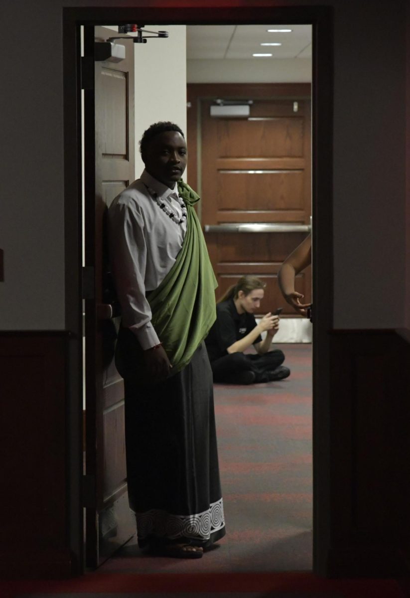 Jeanclaude Tuyisenge, a WKU student from Rawanda, looks through a back door before he performed a traditional African dance at Noir: A night of Black Excellence on Wednesday, Jan. 31. Just remember diversity is important, Tuyisenge said.