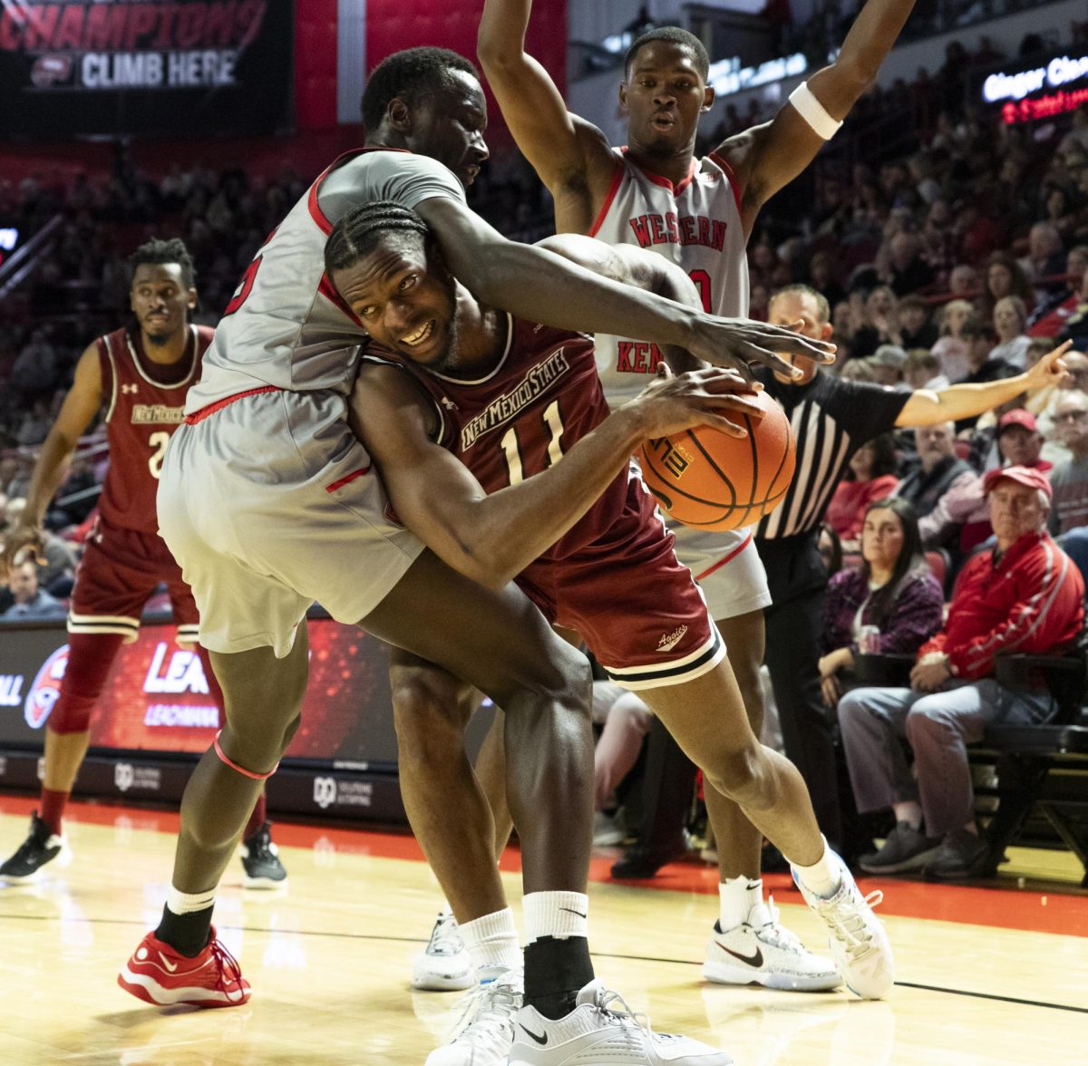 New Mexico State guard Femi Odukale (11) attempts to break past WKU Forward Babacar Faye (5) in WKU’s Senior Night game against NMSU in the Diddle Arena on Feb. 17.