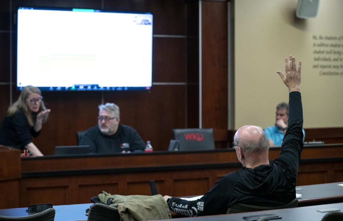 Mac McKerral, journalism coordinator and professor, votes no on a motion during the faculty senate meeting on Thursday, Feb. 22.