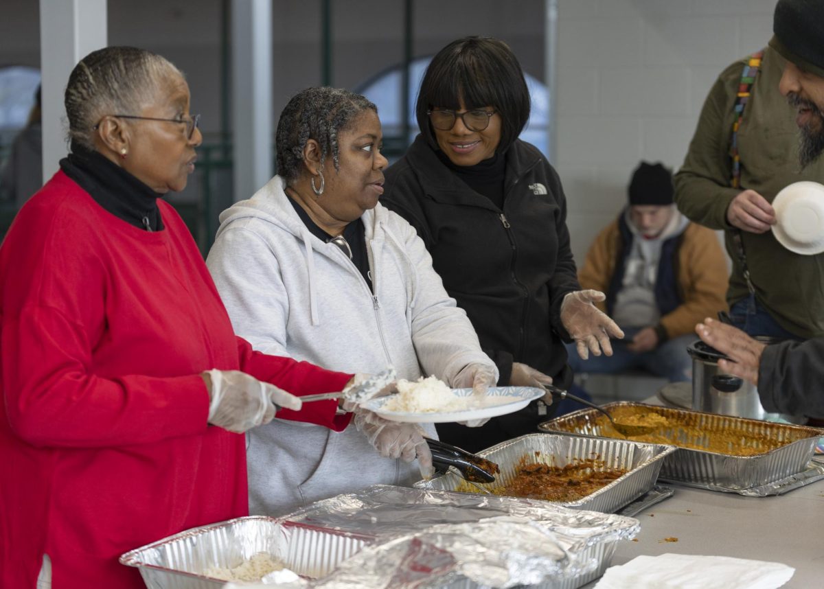 Volunteers Naida Kisdler (left), Carol Phelps (middle), and Johnalma Barnette (right) dish out food donated by Spencer’s Coffee to the people in need at the Warming Center in Kummer Recreation Center on January 19th, 2024.