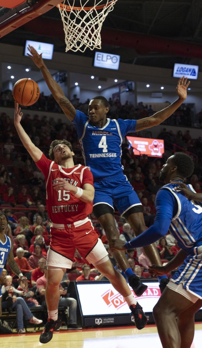 Guard Jack Elden (15) is blocked by MTSU guard Justin Bufford (4) In the Diddle arena on Saturday, Feb 3.