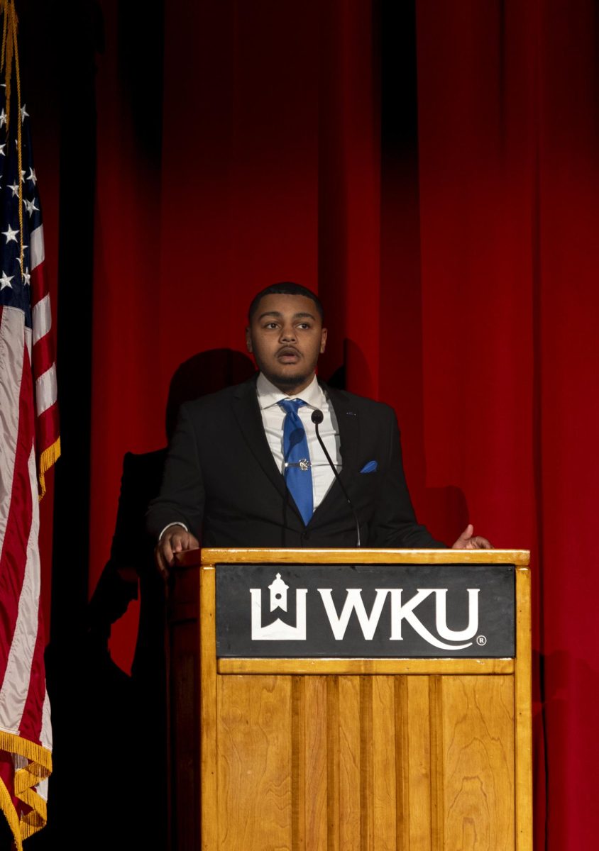 Isaak Kidd, a member of WKU’s Phi Beta Sigma Fraternity, Inc. gives an opening speech and prayer before the Black Experience Showcase in the Downing Student Union auditorium on Wednesday Feb. 28, 2024.