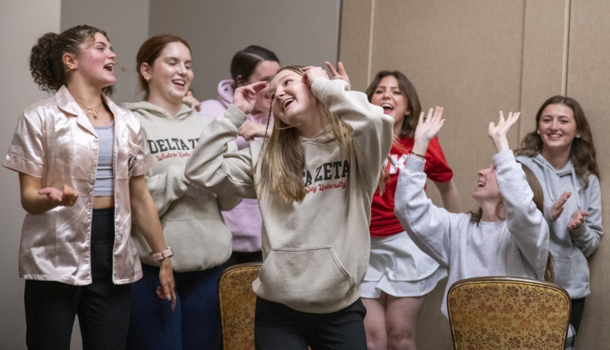 Madyson Bradley, a junior elementary education major, celebrates her second win in musical chairs with her sister in Delta Zeta at Midnight on the Hill on Friday, March 1, 2024.