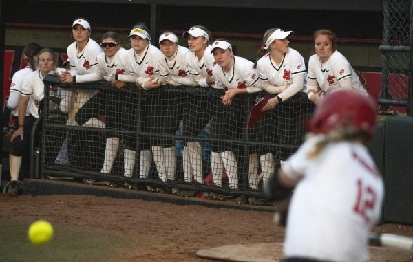 The WKU softball team watches in-fielder Sophie Weber (12) bat during Western Kentucky Universitys game against Southern Illinois University on Sunday, March 3, 2024. 