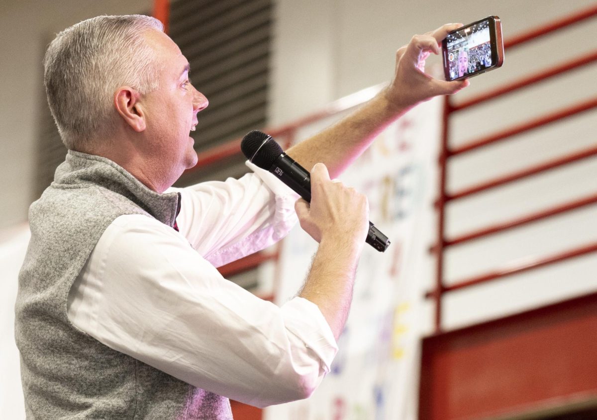 WKU president Timothy Caboni records a video of the crowd at Dance Big Red in Preston Center on Friday, March 8.