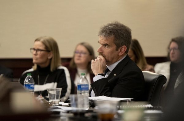 Shane Spiller, faculty regent, listens to a presentation from CPA Partner Jennifer Williams on the NCAA compliance report during the Board of Regents first quarterly meeting on Friday, March 1.