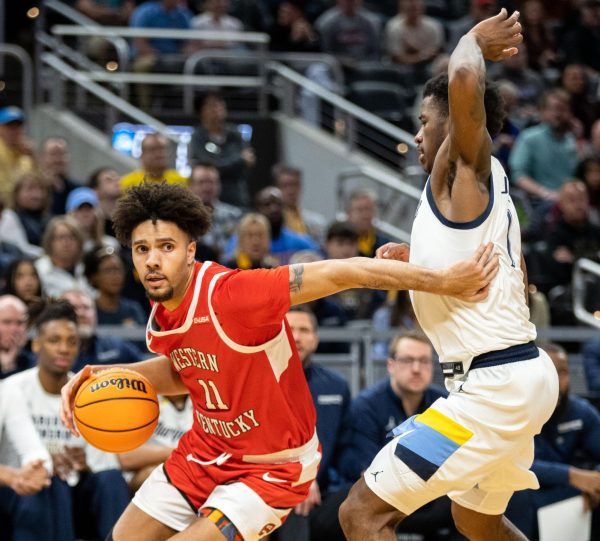 WKU guard Dontaie Allen (11) drives the lane during a game in the Round of 64 against Marquette at the Gainbridge Fieldhouse in Indianapolis on Friday, March 22, 2024 
