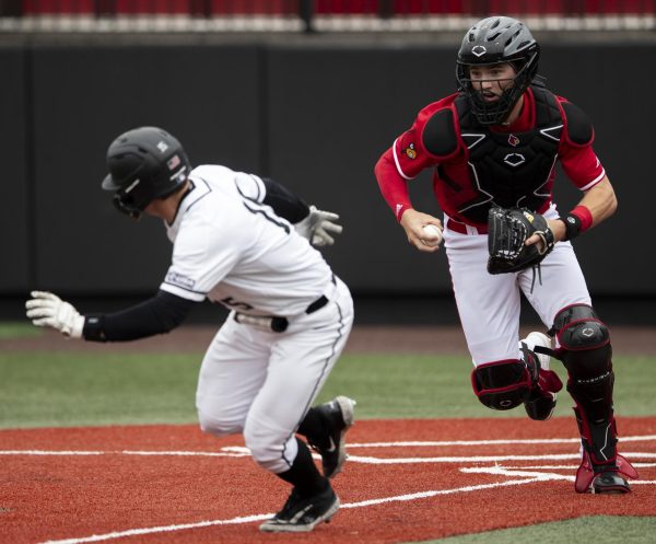 WKU utility player Brady Browning (15) is forced into a chase down by University of Louisville catcher Matt Klein (25) during a game on Tuesday, April 9, 2024.