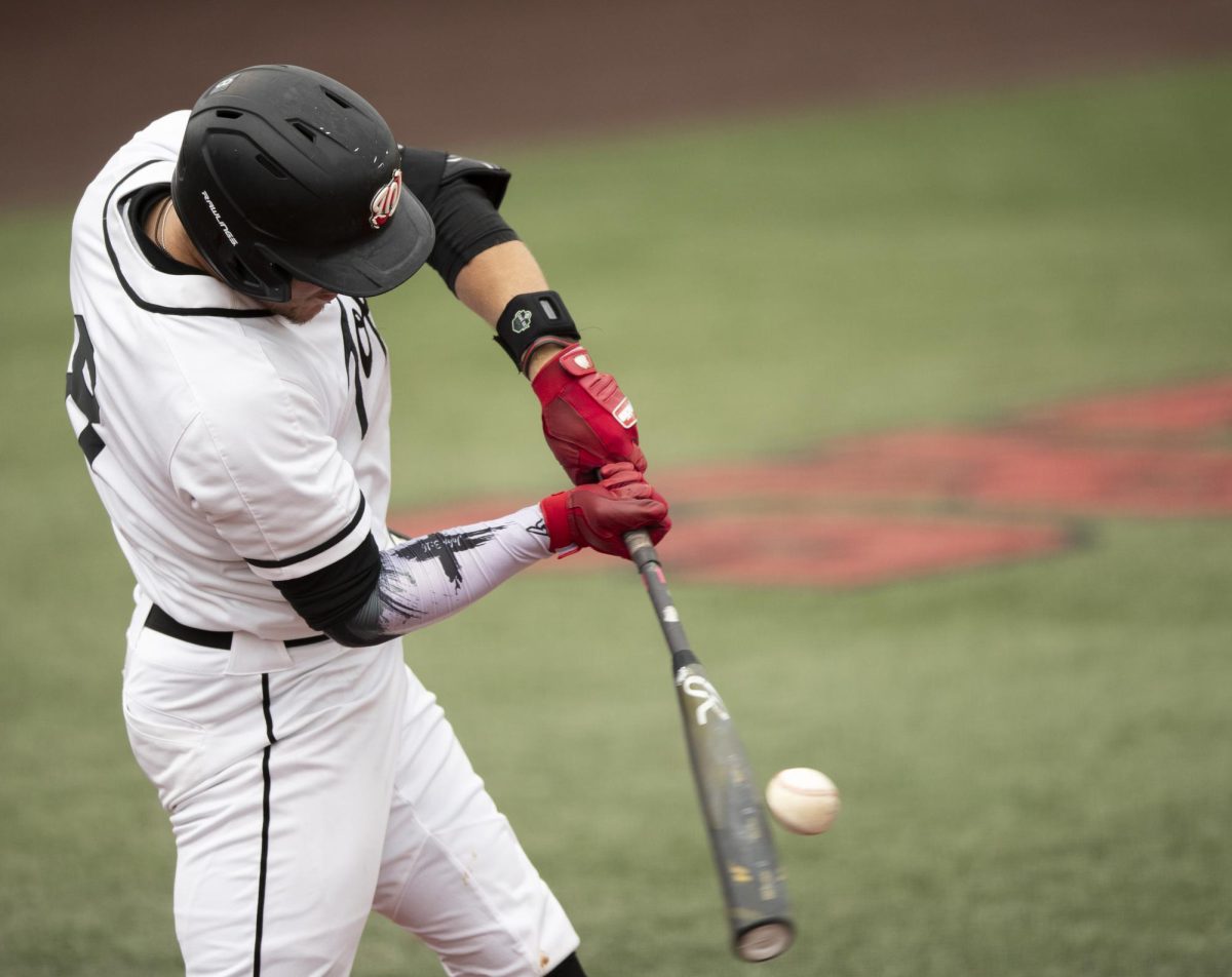 WKU catcher Camden Ross (8) hits the ball during a game against University of Louisville on Tuesday, April 9, 2024.