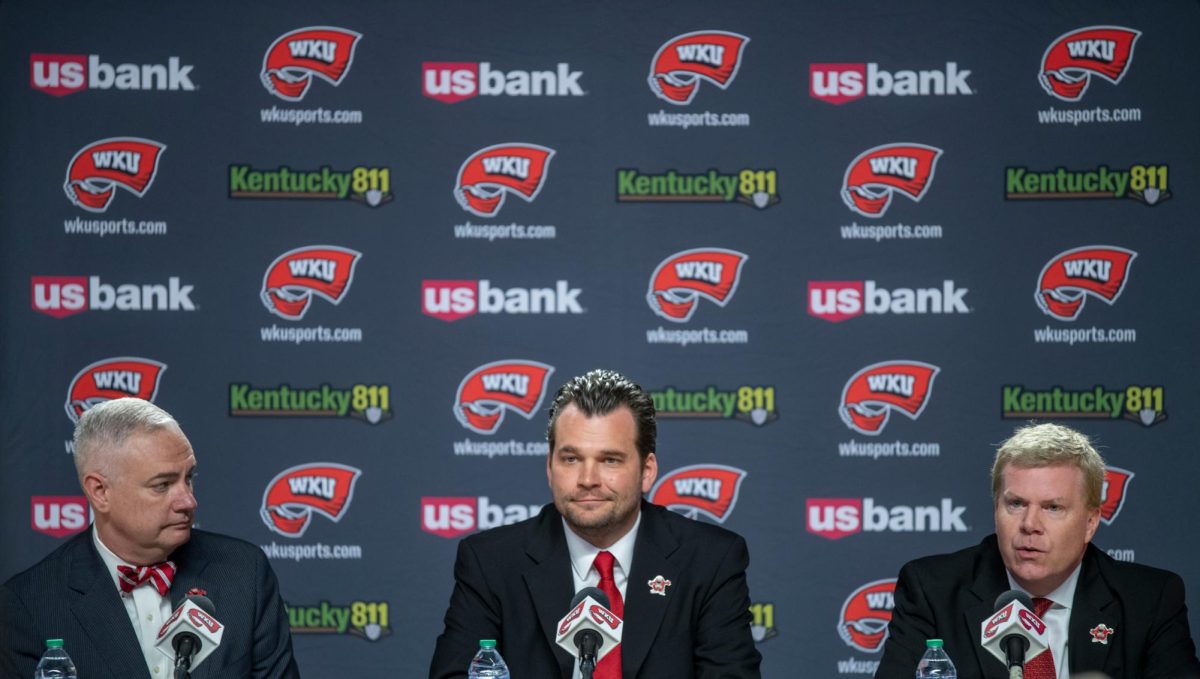 Western Kentucky University Athletic Director, Todd Stewart, (right) gives his opening remarks during a press conference on Wednesday, April 3, 2024. Hank Plona (middle), former assistant coach of Hilltopper basketball, was announced as the new head coach of the WKU basketball program.