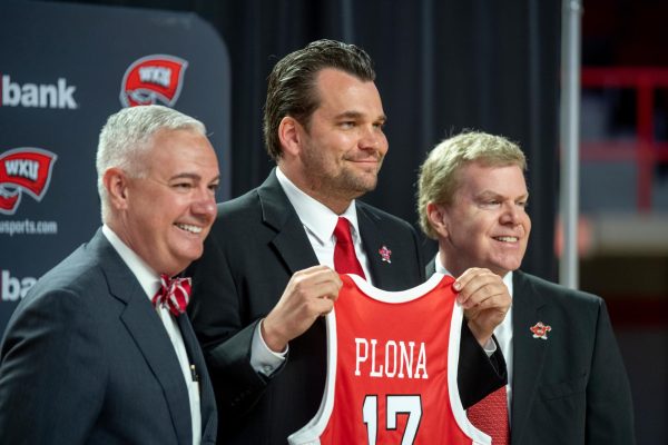 Hank Plona (middle) accepts his jersey on Wednesday, April 3, 2024. Plona, former assistant coach of Hilltopper basketball, was announced as the new head coach of the WKU basketball program.