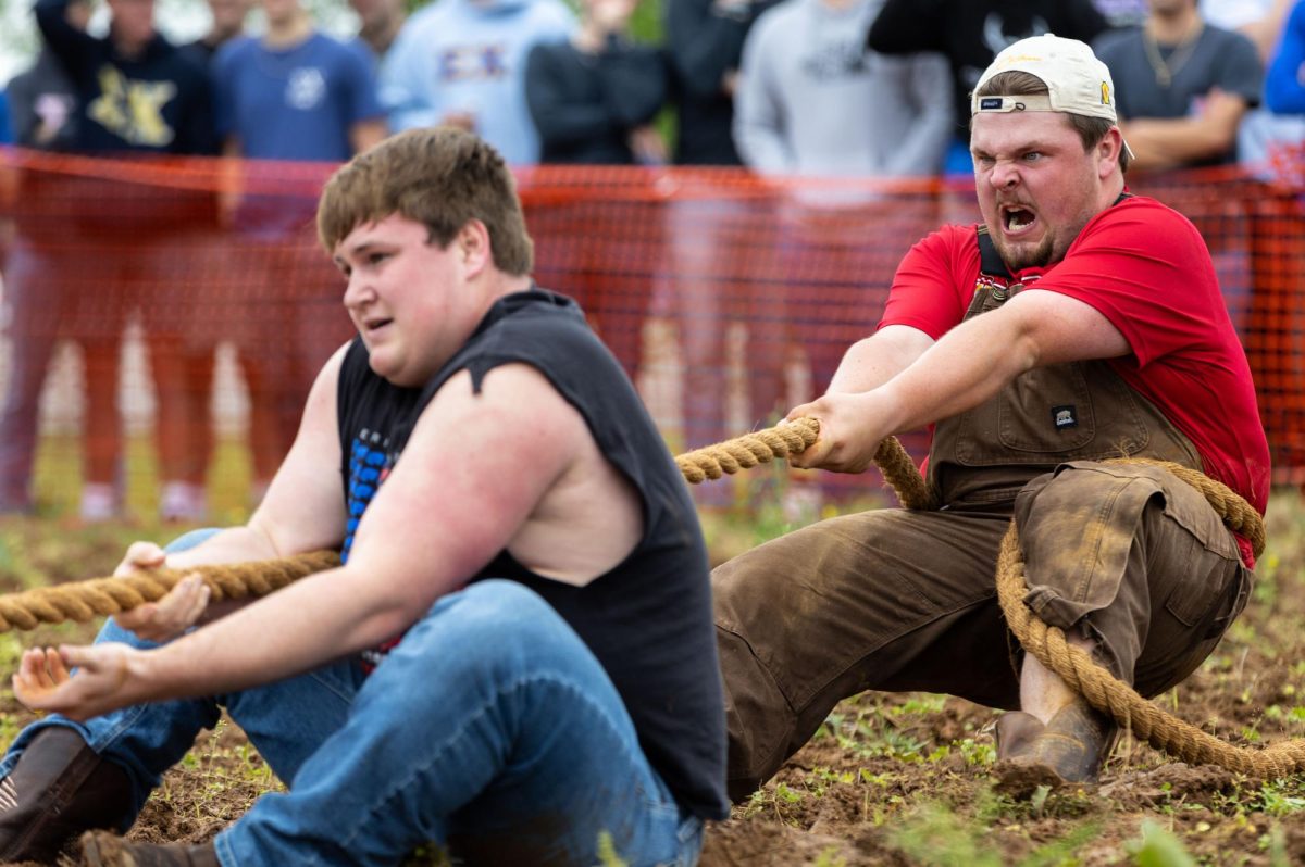 Junior Kappa Alpha member Bernie Sams pulls on the rope during the annual WKU Greek Week “Tug” competition at WKU’s Agriculture & Research Education Center on Friday, April 19, 2024.