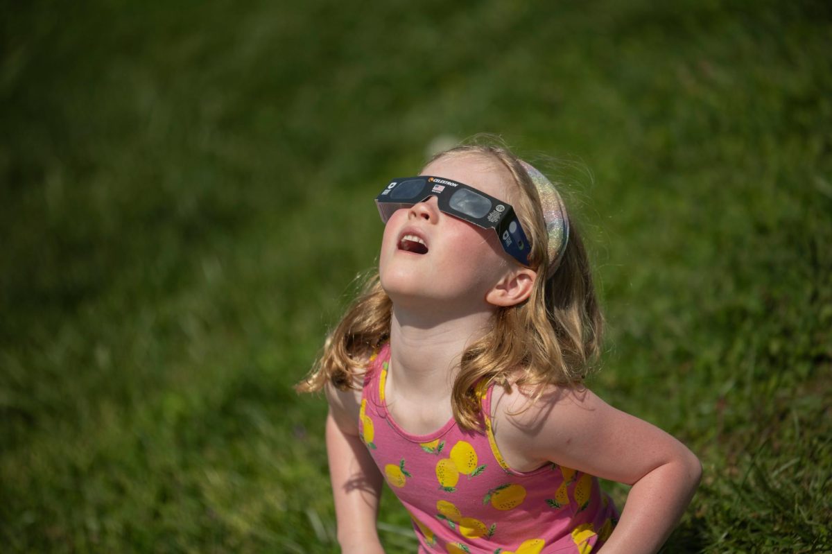 Maddie Pearcy, 7, watches the sky during a total solar eclipse in Evansville, Ind. on Monday, April 8, 2024. 