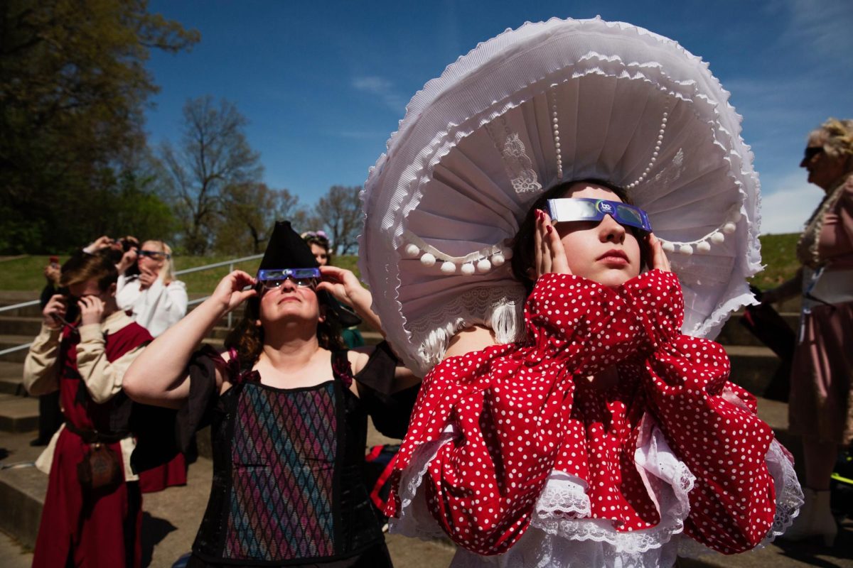 Gina Anzicek (right) and her mother Pam check the position of the moon while waiting for a total solar eclipse at Bob Noble Park in Paducah, Ky. on April 8, 2024. Anzicek adorned a hand-made mushroom costume for her cousin Benjamin Wilhite’s medieval fantasy themed wedding at the park amphitheater