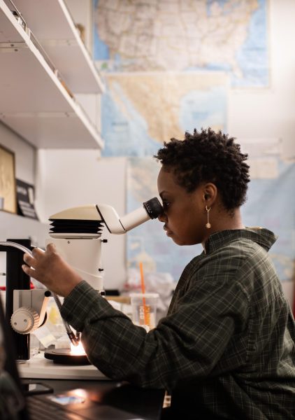 Biology graduate student Monae Taylor observes an ectoparasite known as a bat fly underneath a microscope in professor Carl Dick’s lab on the ground floor of the Ogden Science Hall at WKU on March 27. Taylor specializes in observing bat species and related organisms to understand their nature, “I am just really addicted to bats,” Taylor said. She hopes to understand why bat fly parasites are found on bats in some locations, but not others.