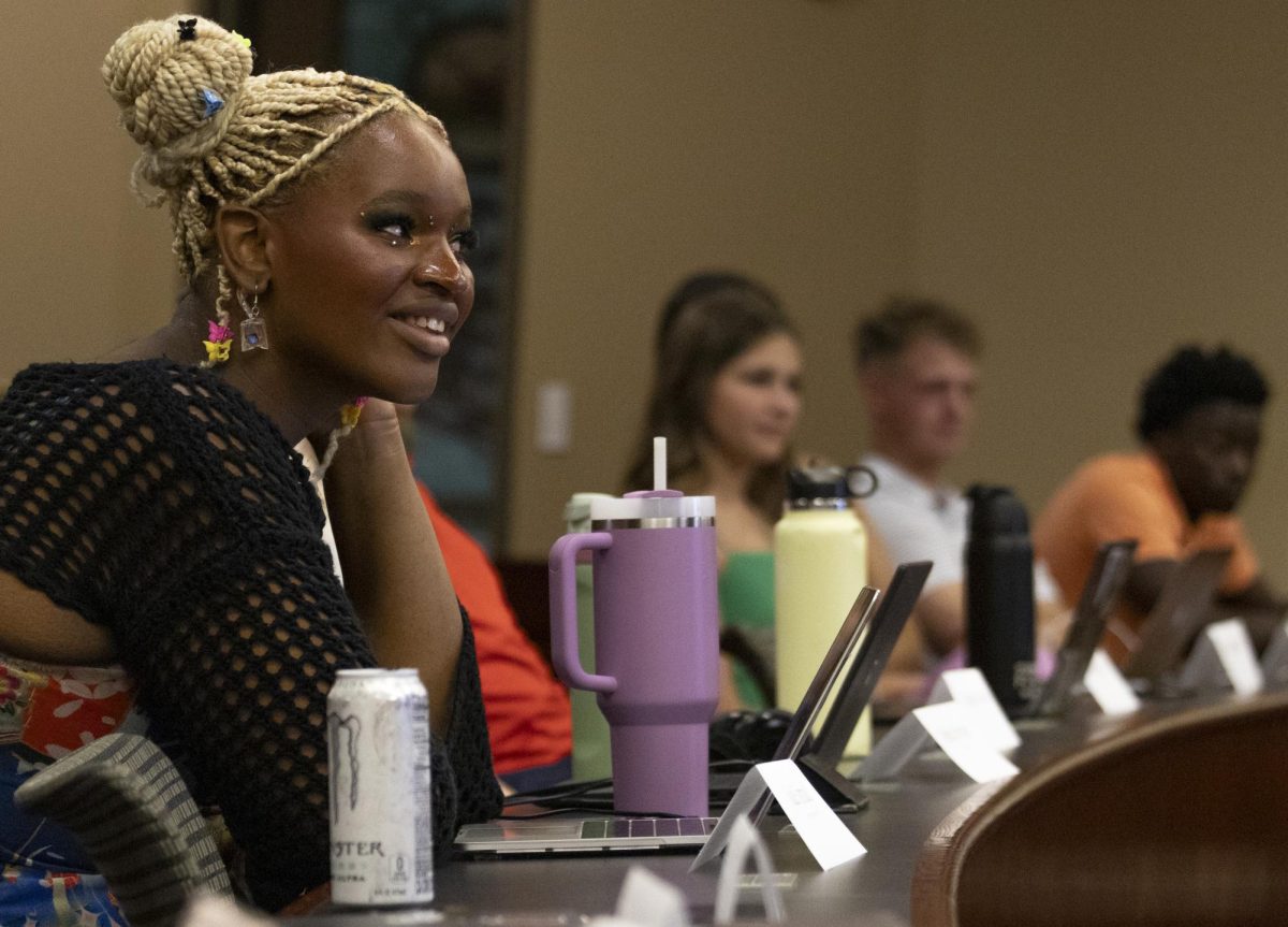 Sophomore senator Jade Ismail listens to WKU President Timothy Caboni as he speaks at SGA senate meeting on Tuesday, Aug. 27, 2024. 