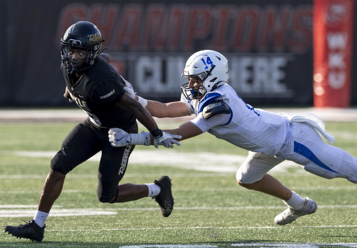 Lexington Christian Academy’s Conrad Hart (14), right, tackles Boyle County’s Geordon Brown (6) during the Rafferty Bowl game at L.T. Smith Stadium on Saturday, Aug. 24, 2024.