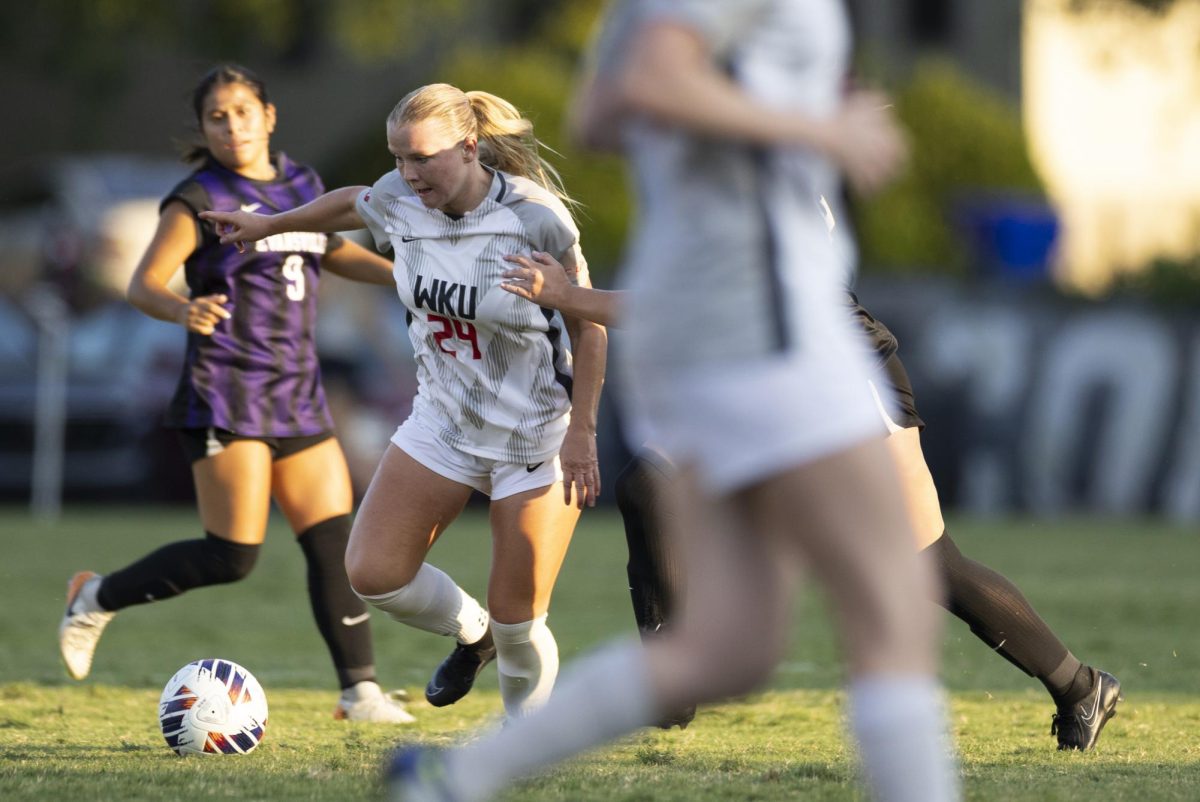 WKU forward Kayla Meyer (24) keeps the ball away from a defender during a game against the University of Evansville at the WKU Soccer Complex on Sunday, Aug. 25, 2024. 