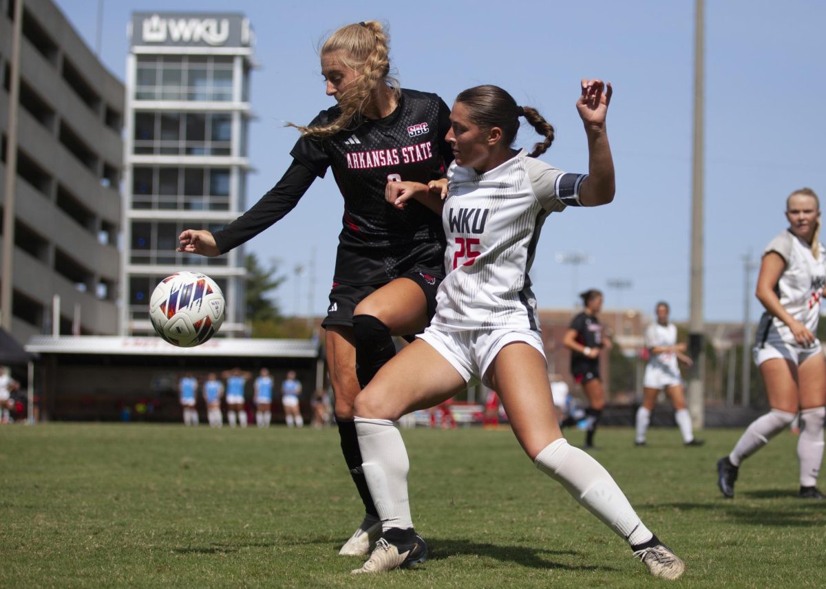 Western Kentucky University forward Lily Rummo tries to steal the ball from an Arkansa State University player during a game at the WKU Soccer Complex on Sunday, Sept. 8, 2024. 