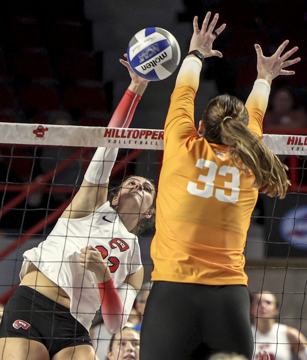 Outside hitter Faith Young (22) spikes the ball during a game against the University of Tennessee in Diddle Arena on Tuesday, Sept. 10, 2024.