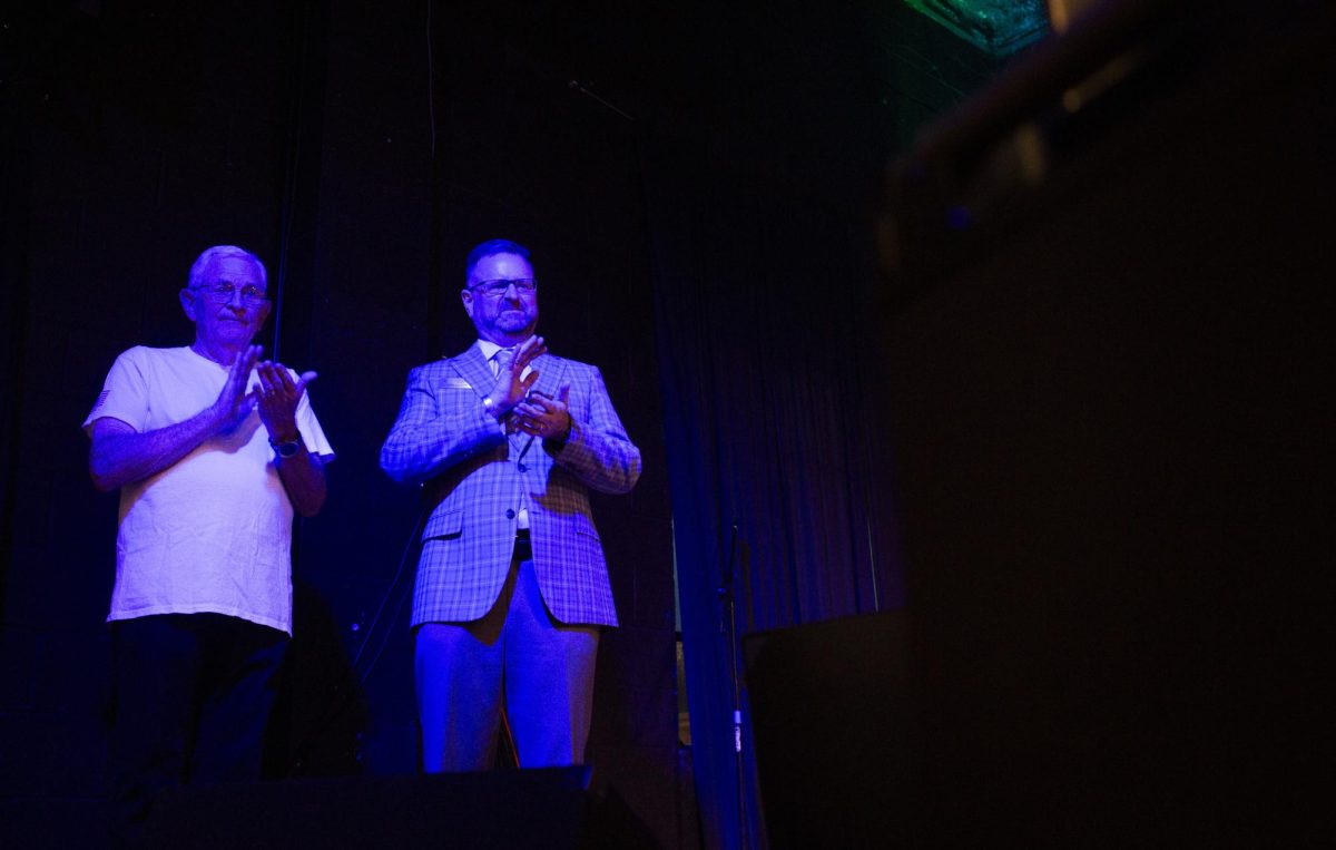 Incumbent Bowling Green mayor Todd Alcott claps next to his father Greg Alcott before receiving an endorsement from Republican Senator Rand Paul during a campaign event at the White Squirrel Brewery in Bowling Green on Sept. 12, 2024. 