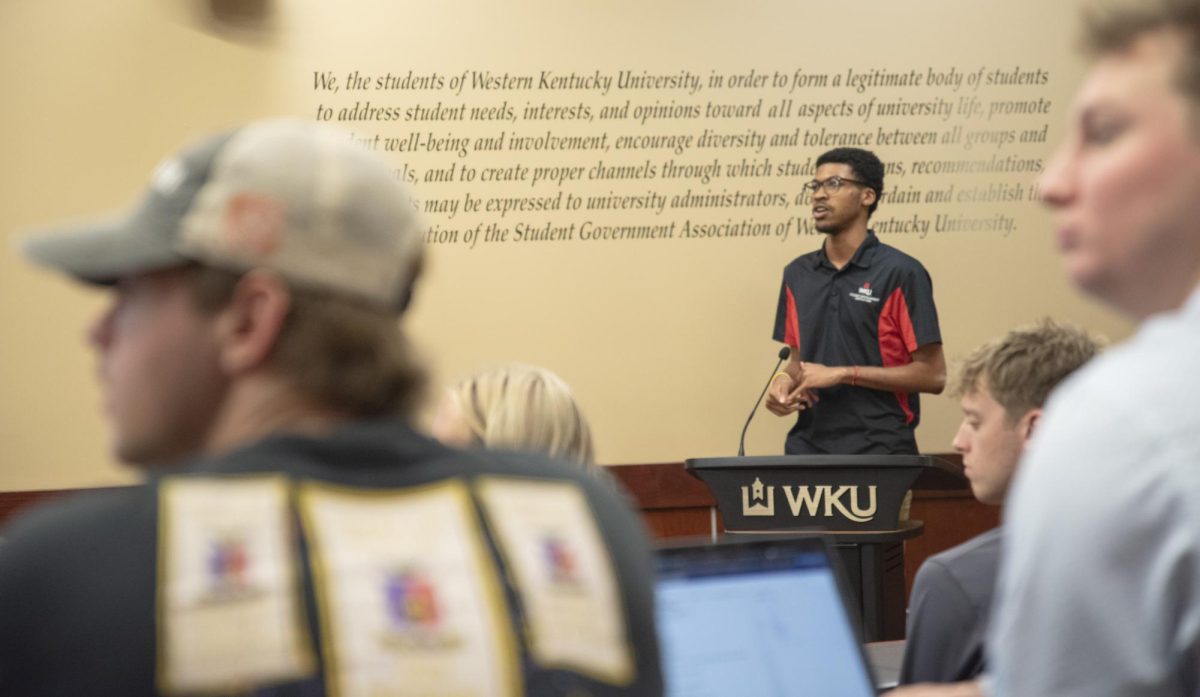 Student Body Vice President Donte Reed stops mid-speech to listen to an SGA member in the SGA chambers on Tuesday, Sept. 17, 2024.