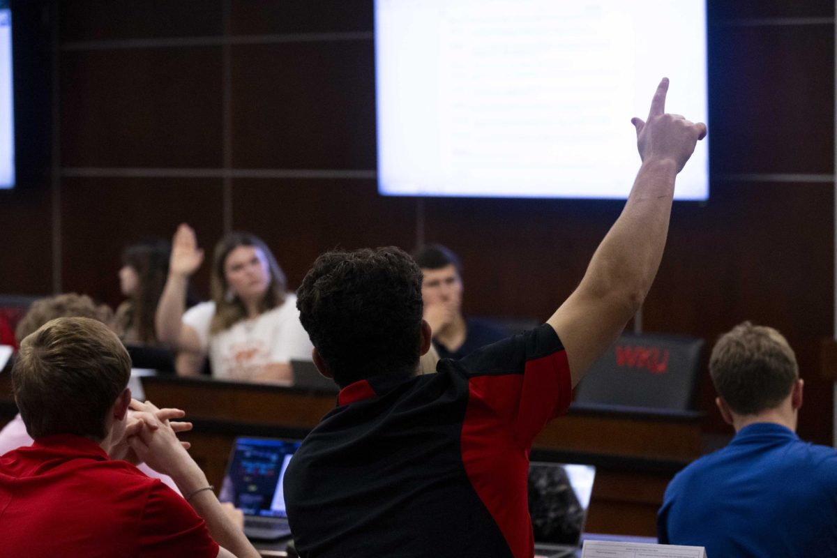 Senator-at-Large Gabe Jerdon raises his hand to ask a question about Caden Lucas’ proposed plan to buy 100 books for the Mahurin Honors College in the Senate Chambers on Tuesday, Sept. 24, 2024. 