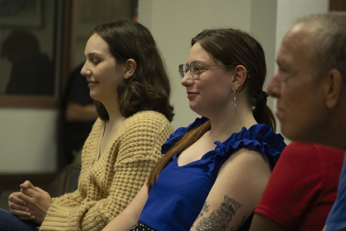 Kirsten Homer listens while panel members answer her question during the New Americans In Kentucky event at the Kentucky Museum on Tuesday, Sept. 24, 2024.