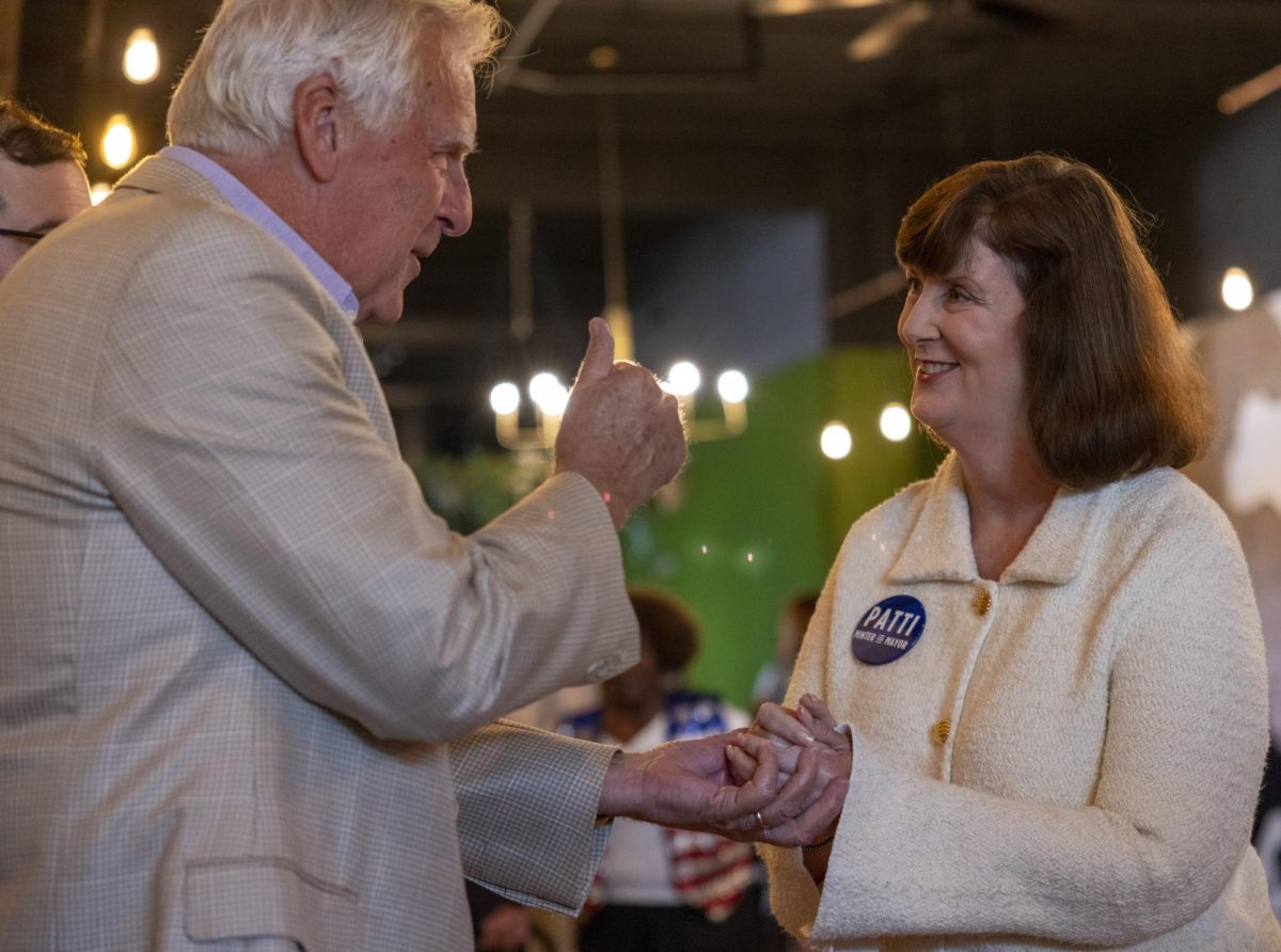 Dr. Patti Minter speaks to Dennis O’Keefe before the start of her campaign fundraiser on Monday, Sept. 16, 2024.