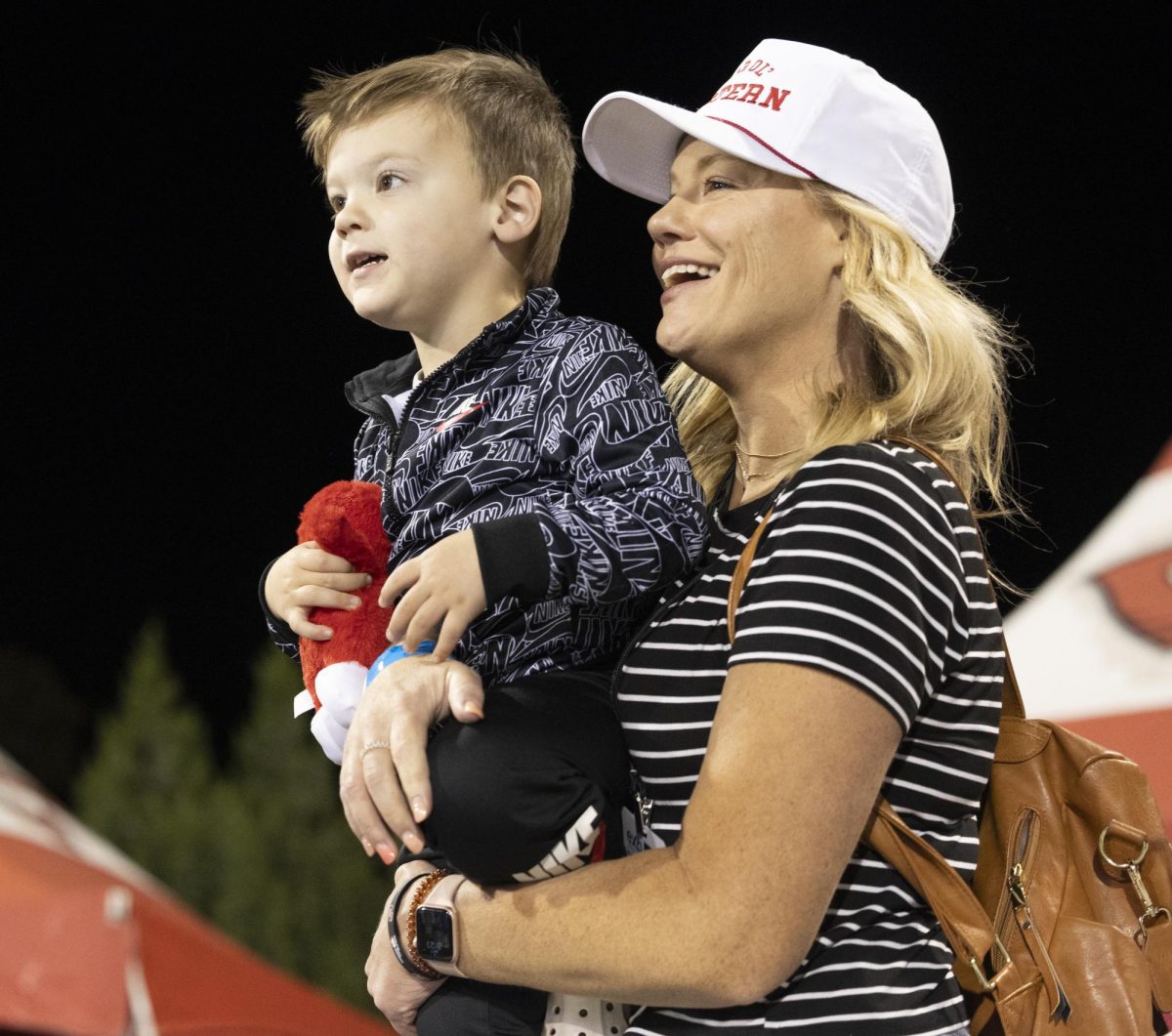 Holly Kirk smiles holding Beau Kirk during a game at L.T. Smith Stadium against Eastern Kentucky University on Saturday, Sept. 7, 2024. 