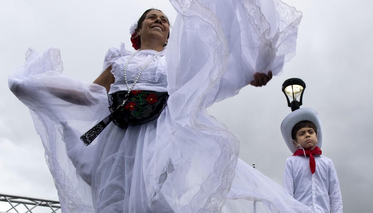 Joana Morelo, left, and Jonathon Reyes perform a traditional folkloric dance from the Mexican state of Veracruz at the Bowling Green International Festival in Circus Square Park on Sept. 28, 2024. 