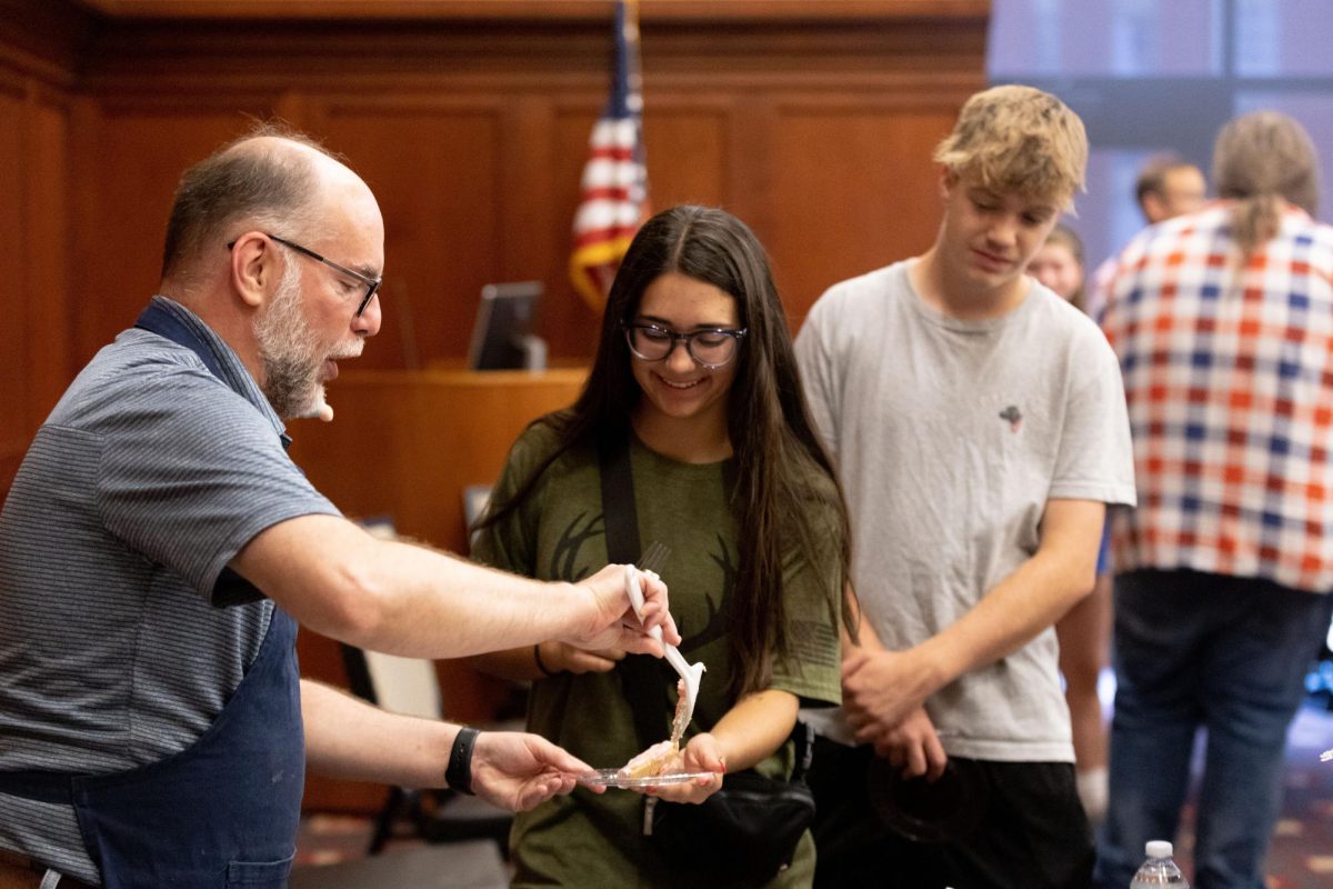 David Serafini gives his dish of kool aid pie to Katie Leduc, sophomore, at the history department's “Great History Bake Off” in the Downing Student Union on September 12. “I love getting to see new things from all different periods,” Leduc said.