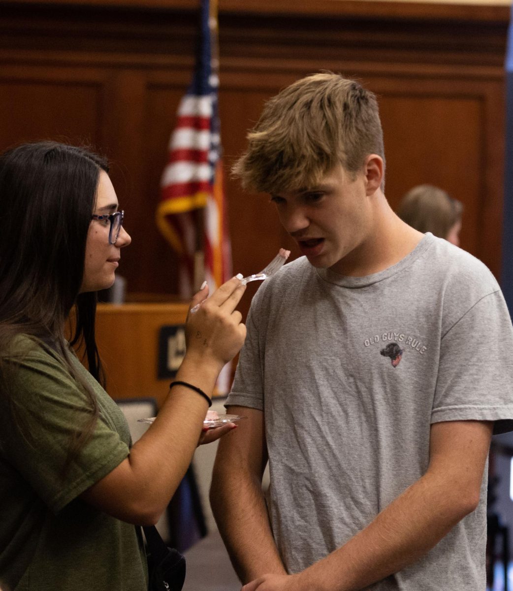 Katie Leduc a sophomore gives Braden Pairs a junior a taste of her kool aid pie during the “Great History Bake Off” in DSU (Downing Student Union) 3rd floor room 3020 on September 12 2024. 