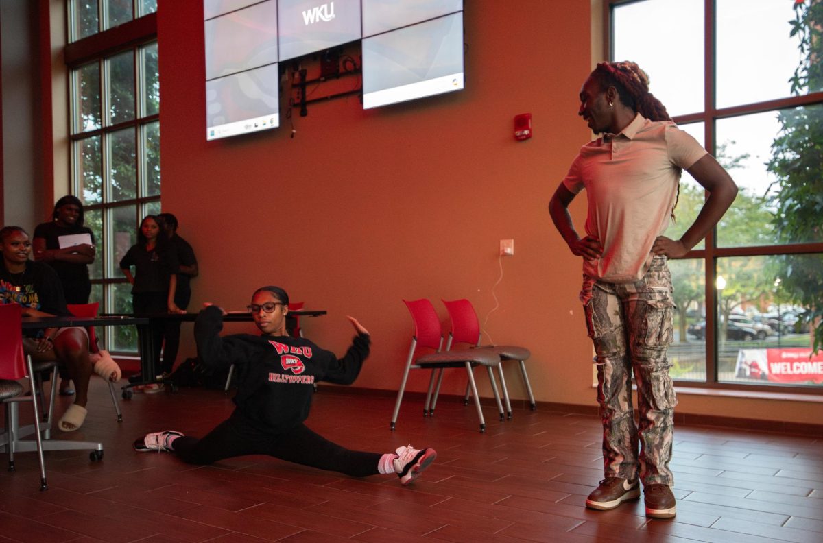 Senior healthcare administration major Kam Brash drops into the splits that leads to her victory in a dance battle against sophomore business administration Jaylin Heater during a round of bingo at the BSA & Bingo event in the DSU Nite Class on Tuesday, Sept. 3, 2024.