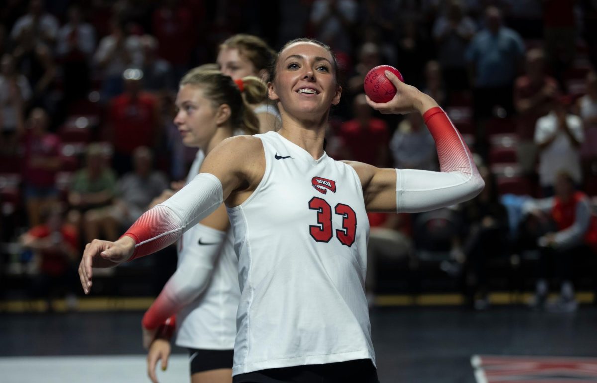 Rightside hitter Kenadee Coyle throws a ball to the crowd before a match against Eastern Illinois in Diddle Arena on Friday, Sept. 20, 2024.