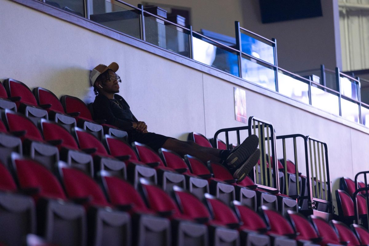 Senior Sports Management major Cameron Elliot watches the WKU vs. Eastern Illinois University volleyball match in Diddle Arena on Friday, Sept. 20, 2024.