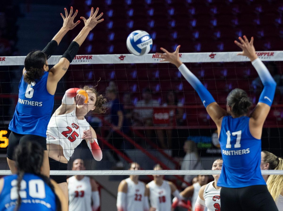 Middle hitter Izzy Van De Wiele (25) goes for a kill during a match against Eastern Illinois University in Diddle Arena on Friday, Sept. 20, 2024.