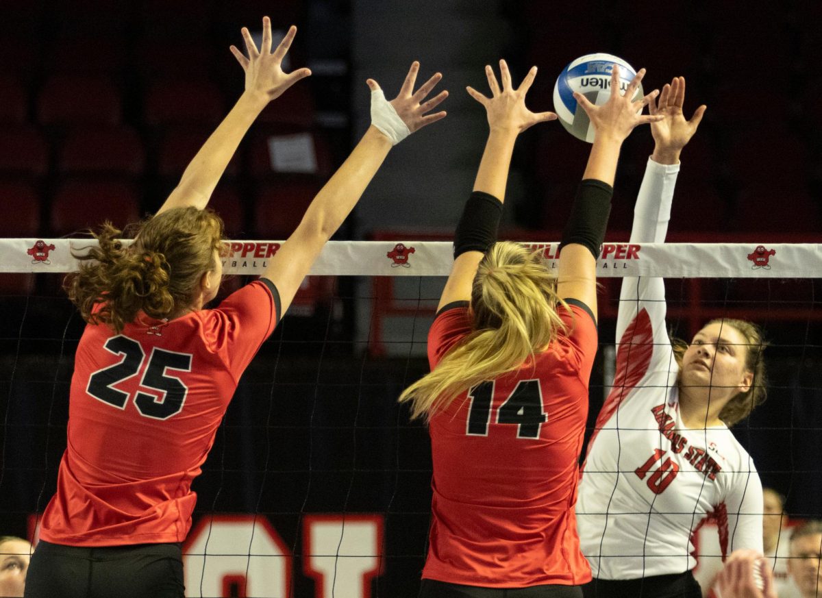 Middle hitter, Izzy Van De Wiele (25), and setter Callie Bauer (14) go up to block a ball against Arkansas State University at Diddle Arena on Friday, Sept. 20, 2024. 