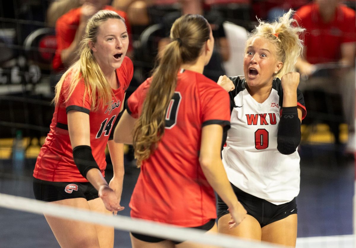 Defensive specialist Callahan Wiegandt (0), right, celebrates with teammates during a game against Arkansas State University in Diddle Arena on Friday, Sept. 20, 2024.